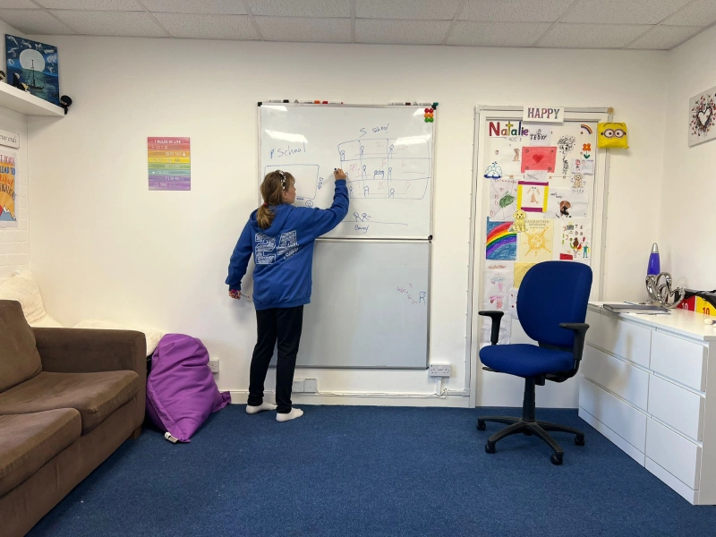 Girl writing on a white board